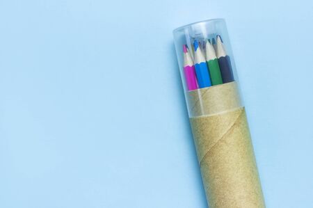 Back to school concept. Color pencils in pencil case on blue background top view flat lay with copy space. Wooden colored pencils for drawing, objects for creativity, school supplies close-up.の写真素材