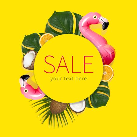 Creative concept of summer sales. Inflatable pink mini flamingo tropical palm leaf monstera coconut orange on yellow background pool float party. Flat lay Flamingo Trend Inflatable Toy Discounts sale.の写真素材