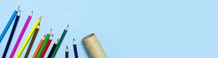 Back to school concept. Color pencils on blue background top view flat lay with copy space. Wooden colored pencils for drawing, objects for creativity, school supplies close-up.の写真素材
