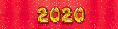 2020 inflatable golden numbers with confetti in the shape of stars on red background. New year winter decoration, holiday symbol. Merry Christmas greeting card. Happy New Year. Flat lay.の写真素材