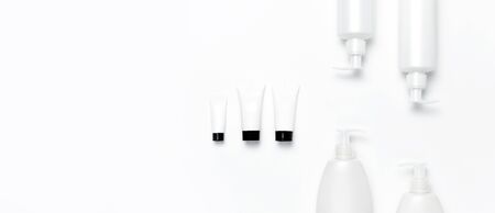 White cosmetic bottle containers on white background top view flat lay with space for text. Cosmetics SPA branding mock-up, Natural organic beauty product concept, Minimalism cosmetics style.の写真素材