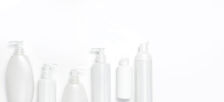 White cosmetic bottle containers on white background top view flat lay with space for text. Cosmetics SPA branding mock-up, Natural organic beauty product concept, Minimalism cosmetics style.の写真素材