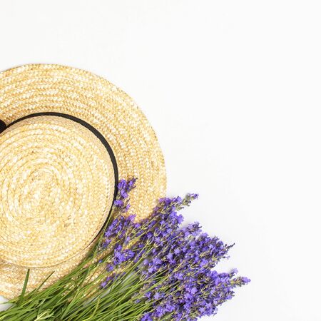 Summer fashion composition. Fresh flowers of purple lavender, women's summer straw hat on light gray background. Flat lay top view copy space. Lavender floral background flower card. Female accessory.の写真素材