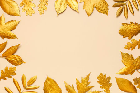 Flat lay creative autumn composition. Frame from Golden leaves on beige background top view copy space. Fall concept. Autumn background. Minimal concept idea, floral design.の写真素材