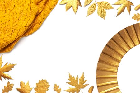 Fashionable vintage modern golden frame, knitted orange sweater, golden autumn leaves isolated on white background. Photo frame, mirror frame, baguette, stylish interior item. Autumn, fall concept.の写真素材