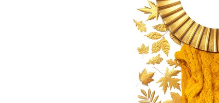 Fashionable vintage modern golden frame, knitted orange sweater, golden autumn leaves isolated on white background. Photo frame, mirror frame, baguette, stylish interior item. Autumn, fall concept.の写真素材
