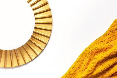 Fashionable vintage modern golden frame, knitted orange sweater isolated on white background. Photo frame, mirror frame, baguette, stylish interior item. Autumn, fall concept.の写真素材