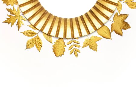 Fashionable vintage modern golden frame and golden autumn leaves isolated on white background. Photo frame, mirror frame, baguette, stylish interior item. Aged wooden gilded frame. Autumn fall concept.の写真素材