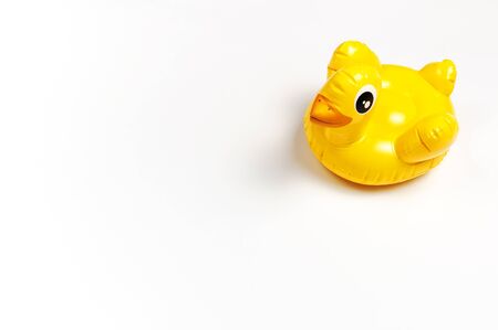 Inflatable mini yellow chicken or duckling on white background, pool float party. Flat lay copy space. Trend Inflatable Children toy for swimming. Creative summer beach concept. Layout for design.の写真素材