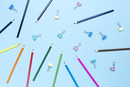 Color pencils on pastel blue background top view flat lay with copy space. Wooden colored pencils for drawing, objects for creativity, school supplies close-up. Back to school concept.の写真素材