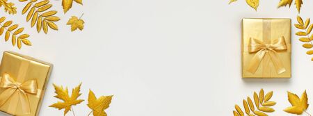 Flat lay Autumn holiday concept. Golden gift or present box with ribbon and golden autumn leaves on light gray background top view copy space. Surprise, congratulation, birthday, greeting card.の写真素材