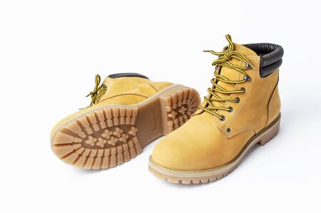 Yellow men's work boots from natural nubuck leather isolated on white background. Trendy casual shoes, youth style. Concept of advertising autumn winter shoes, sale, shop.の写真素材