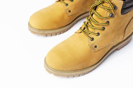 Close-up Yellow men's work boots from natural nubuck leather isolated on white background. Trendy casual shoes, youth style. Concept of advertising autumn winter shoes, sale, shop.の写真素材