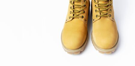 Close-up Yellow men's work boots from natural nubuck leather isolated on white background. Trendy casual shoes, youth style. Concept of advertising autumn winter shoes, sale, shop.の写真素材