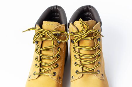 Close-up Yellow men's work boots from natural nubuck leather isolated on white background. Trendy casual shoes, youth style. Concept of advertising autumn winter shoes, sale, shop.の写真素材