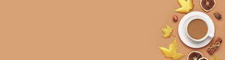 Autumn composition. White cup of coffee or cocoa, golden maple leaves, cinnamon, dried orange, pine cone, pomegranate on beige background. Flat lay, top view, copy space. Autumn, fall concept.の写真素材