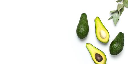 Ripe fresh avocado, eucalyptus twigs isolated on white background with shadow top view Flat lay copy space. Fruits Healthy food concept, diet, healthy lifestyle, organic avocado.の写真素材