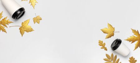 Coffee or tea paper cups, golden autumn leaves on light gray background top view flat lay. Take away coffee cup, mockup. Coffee love, layout for design. Fall concept. Autumn background. Copy space.の写真素材