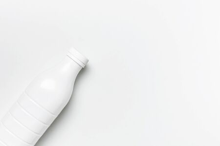 White plastic bottle containers for dairy products on light gray background top view flat lay. Plastic Kefir Yogurt Milk Bottle. Packaging template mockup. Layout for your design.の写真素材