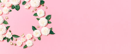 Flowers composition. Frame in the form of circle of white fresh roses and green leaves on gentle...
