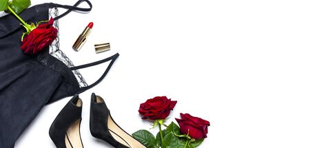 Female black T-shirt jacket with lace, classic shoes, red lipstick and rose flowers on white background top view flat lay. Beauty fashion background. Sexy clothes, women's holiday.の写真素材