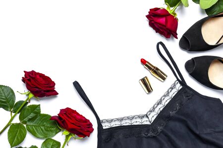 Female black T-shirt jacket with lace, classic shoes, red lipstick and rose flowers on white background top view flat lay. Beauty fashion background. Sexy clothes, women's holiday.の写真素材