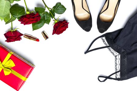 Female black T-shirt jacket with lace, classic shoes, gift box, red lipstick and rose flowers on white background top view flat lay copy space. Beauty fashion background. Sexy clothes, women's holiday.の写真素材