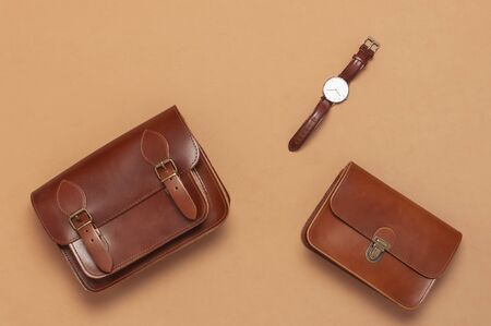 Brown leather women bag, stylish wristwatch on brown beige background top view flat lay copy space. Fashionable women's accessories. Sales Fashion Concept. Stylish Lady Clothes. Luxury Leather Bag.の写真素材