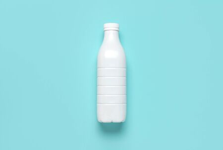 White plastic bottle containers for dairy products on blue turquoise background top view flat lay. Plastic Kefir Yogurt Milk Bottle. Packaging template mockup. Layout for your design.の写真素材
