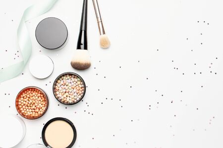 Set of decorative cosmetics makeup brushes blush face balls star confetti holiday ribbons on light background top view Flat lay copy space. Beauty blogger concept Fashion background Makeup accessories.の写真素材
