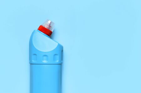 Blue plastic bottle for liquid detergent, cleaning agent, bleach, antibacterial gel on blue background. House cleaning concept. Flat lay top view. Cleaning accessories.の写真素材