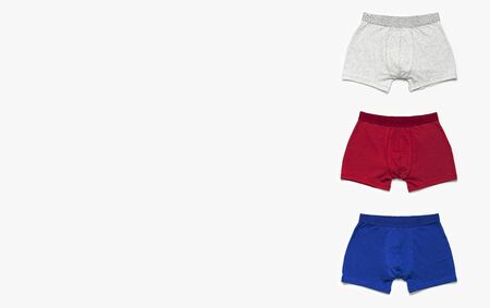 Mens underwear, set of multi-colored underpants on white background flat lay top view copy space. Fashion blog, natural underwear, advertising, shopping concept. Pants boxers.の写真素材