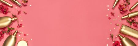 Cosmetics Branding Concept. Cosmetics, spring pink flowers, gold stars confetti on pink background. Cosmetic mock up gold bottles. Flat lay top view copy space. Cosmetic products, beauty background.の写真素材