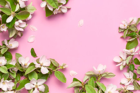 Spring nature background. Beautiful blooming spring branches on pink background flat lay top view...
