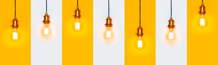 Creative idea concept, designer lamp, modern interior item. Vintage fashionable edison lamp on gray and yellow background. Top view flat lay. Lighting, electricity, pattern with lamp bulb.の写真素材