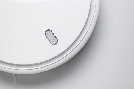 Modern robot vacuum cleaner on gray background flat lay. New technologies, quick house cleaning,...