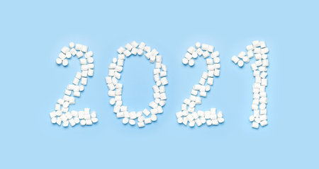Numbers 2021 from white marshmallows on blue background flat lay top view copy space. New Year 2021....