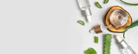 natural cosmetics concept. Cosmetic oil, serum, gel with aloe vera extract in glass container with pipette on gray background. organic cosmetics. Top view flat lay. Cosmetics SPA branding mock-up.の写真素材