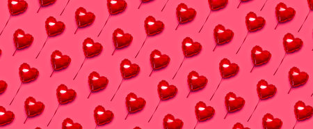 Pattern of Red balloon in the shape of heart on pink background top view flat lay copy space. love concept. Holiday Object, Birthday, Valentine's Day, Wedding. party decor. greeting card.の写真素材