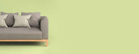 Modern scandinavian gray fabric sofa with soft pillows on wooden legs on light green background flat lay front view. Furniture, single piece of interior object. Stylish trendy couch.の写真素材