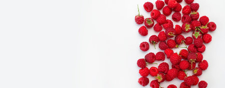 Ripe juicy fresh raspberries on white background flat lay top view. Raspberry pattern. Organic raspberries, healthy food, vitamins, summer berry fruit background. Raspberry harvest.の写真素材