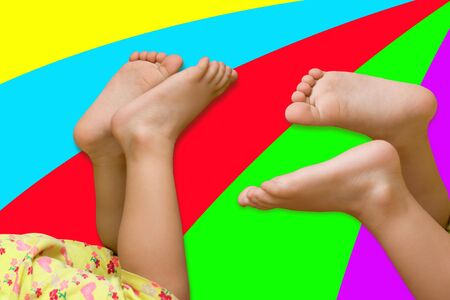 Two pairs feet of children on a bright backgroundの写真素材