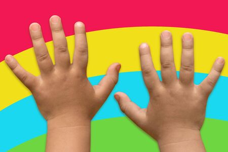 Hands of the child of one year on a bright backgroundの写真素材