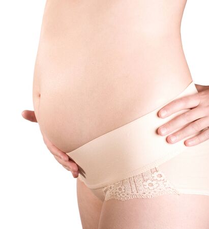 pregnant woman holding her belly on white backgroundの写真素材