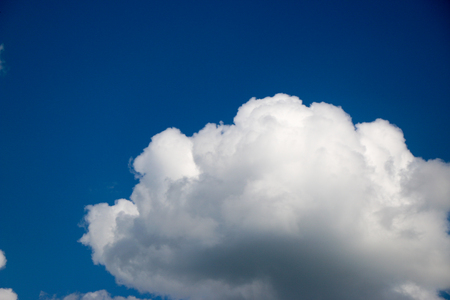 White clouds against the blue sky, a summer day in sunny weatherの写真素材