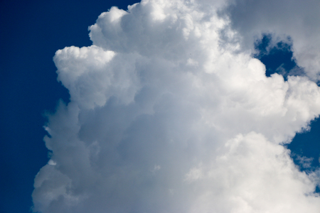 White clouds against the blue sky, a summer day in sunny weatherの写真素材