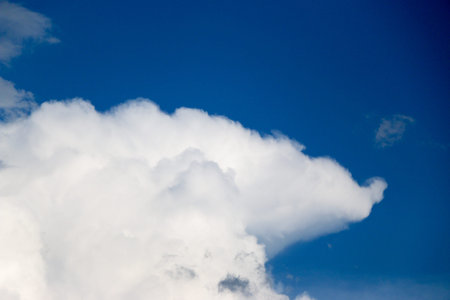 White clouds against the blue sky, a summer day in sunny weather
