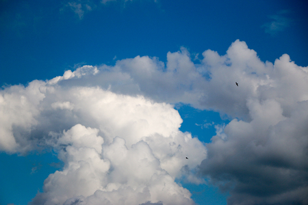 White clouds against the blue sky, a summer day in sunny weatherの写真素材
