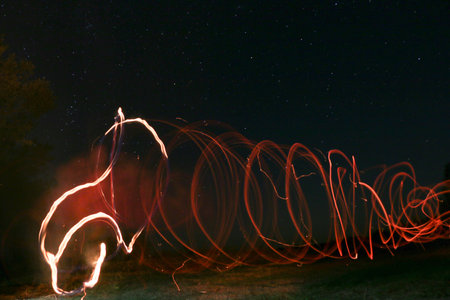 Starry sky and drawings with fire and lanterns long exposure, natural landscape, Ukraine