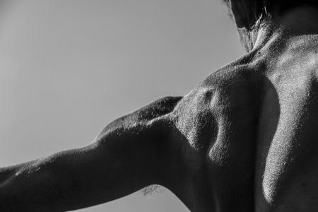 Black and white image of a muscular man, athletic body, handsome masculine muscle shapes, relief....
